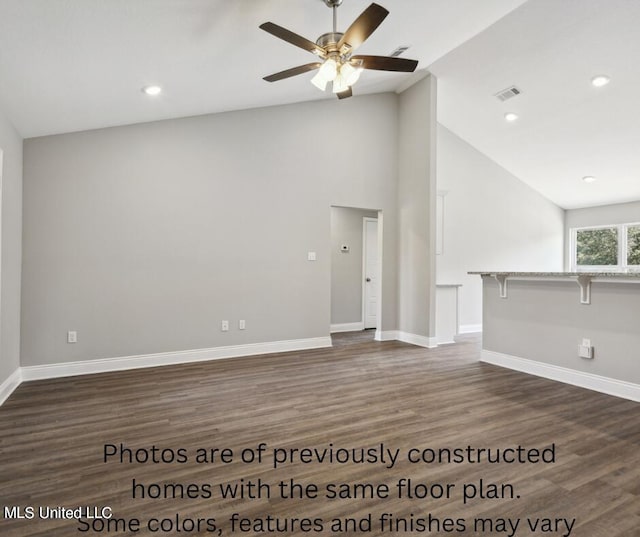 unfurnished living room with ceiling fan, vaulted ceiling, and dark hardwood / wood-style flooring