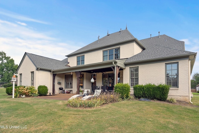 rear view of property with a porch and a yard