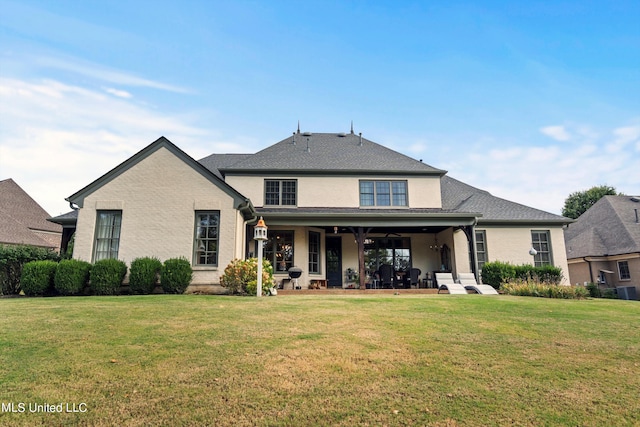 back of property featuring a porch and a lawn