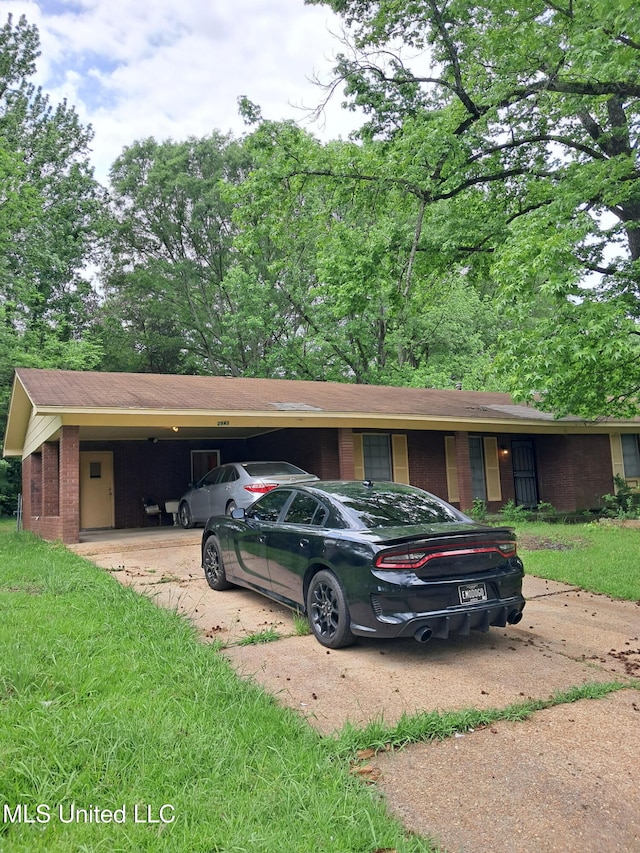 2943 Suncrest Dr, Jackson, MS 39212 - view of parking / parking lot with concrete driveway and a carport