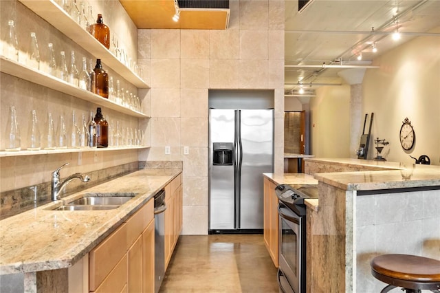 701 N 15th St Unit 504W, Saint Louis, MO 63103 - kitchen with appliances with stainless steel finishes, a sink, open shelves, light stone countertops, and tile walls