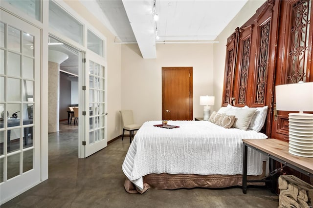 701 N 15th St Unit 504W, Saint Louis, MO 63103 - bedroom featuring french doors, concrete flooring, and track lighting