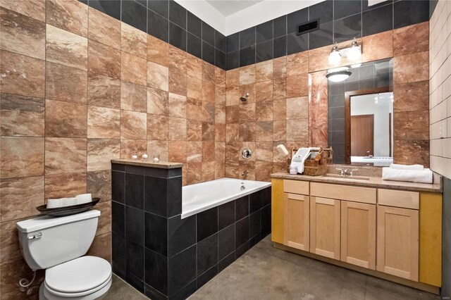 701 N 15th St Unit 504W, Saint Louis, MO 63103 - full bathroom with tile walls, toilet, vanity, concrete flooring, and tiled shower / bath combo
