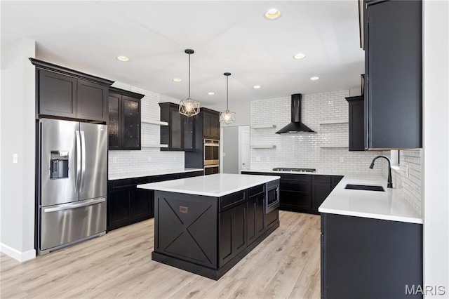 1 Hadleigh, Windsor Park, Lake St Louis, MO 63367 - kitchen with stainless steel appliances, wall chimney exhaust hood, decorative backsplash, a kitchen island, and a sink