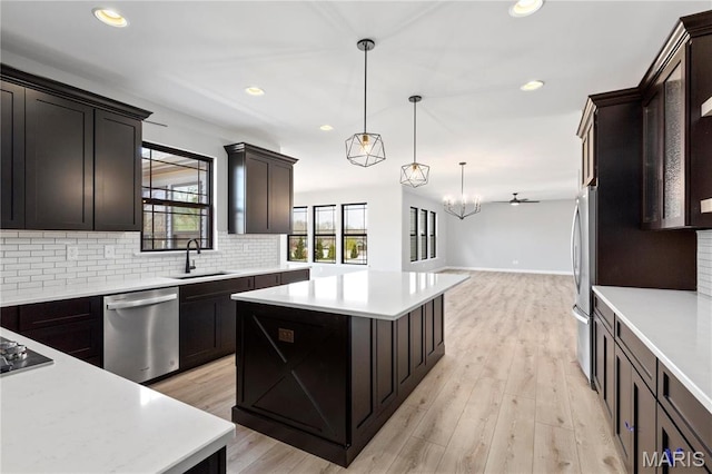 1 Hadleigh, Windsor Park, Lake St Louis, MO 63367 - kitchen with appliances with stainless steel finishes, a sink, backsplash, light countertops, and recessed lighting