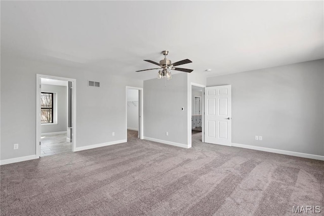 1 Hadleigh, Windsor Park, Lake St Louis, MO 63367 - unfurnished bedroom with carpet floors, a walk in closet, baseboards, and connected bathroom