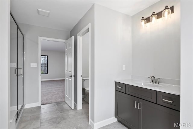 1 Hadleigh, Windsor Park, Lake St Louis, MO 63367 - bathroom featuring toilet, vanity, a stall shower, and baseboards