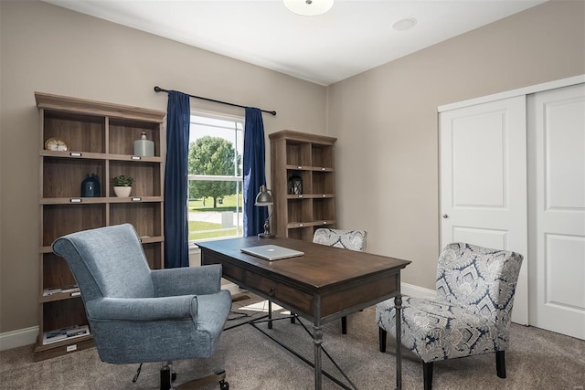 carpeted office space featuring baseboards