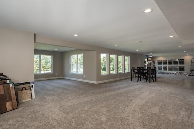 living room featuring carpet flooring, recessed lighting, baseboards, and healthy amount of natural light