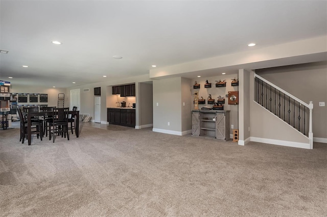 living room with light carpet, bar, recessed lighting, stairway, and baseboards