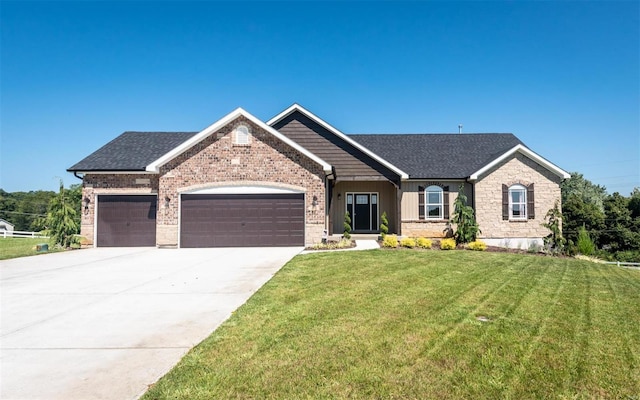 view of front facade featuring an attached garage, a front yard, driveway, and a shingled roof