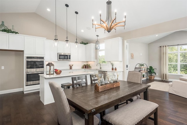 dining room featuring dark wood-style floors, a chandelier, baseboards, recessed lighting, and high vaulted ceiling