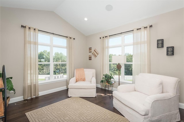 living area featuring healthy amount of natural light, lofted ceiling, dark wood-type flooring, baseboards, and recessed lighting