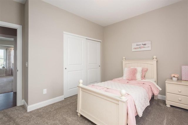 bedroom featuring carpet flooring, a closet, and baseboards