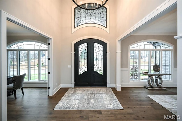 712 Silver Buck Ln, Chesterfield, MO 63005 - entryway featuring arched walkways, a chandelier, dark wood-type flooring, a high ceiling, and french doors