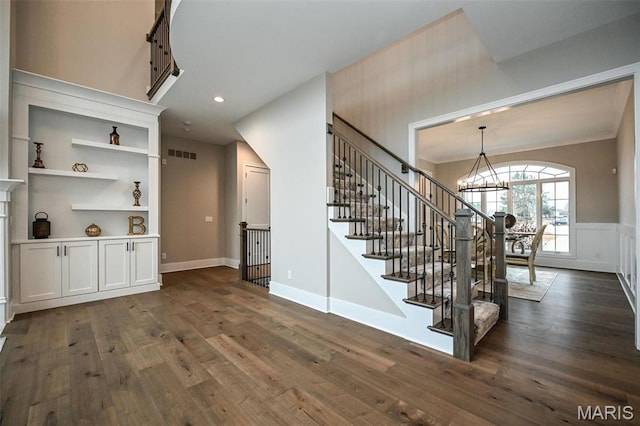 712 Silver Buck Ln, Chesterfield, MO 63005 - stairs with a chandelier, hardwood / wood-style floors, recessed lighting, wainscoting, and a decorative wall