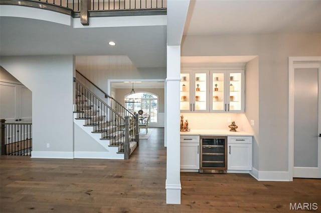 712 Silver Buck Ln, Chesterfield, MO 63005 - indoor dry bar featuring beverage cooler, dark wood finished floors, stairs, recessed lighting, and a chandelier
