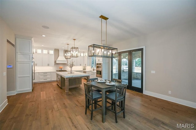 712 Silver Buck Ln, Chesterfield, MO 63005 - dining area with dark wood-style floors, recessed lighting, a chandelier, and french doors