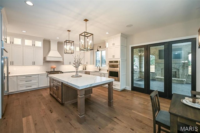 712 Silver Buck Ln, Chesterfield, MO 63005 - kitchen featuring custom exhaust hood, tasteful backsplash, recessed lighting, stainless steel appliances, and white cabinetry