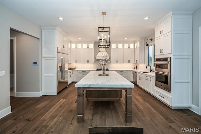 712 Silver Buck Ln, Chesterfield, MO 63005 - kitchen featuring stainless steel appliances, white cabinets, dark wood finished floors, and recessed lighting