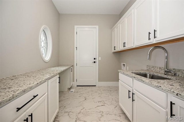 712 Silver Buck Ln, Chesterfield, MO 63005 - washroom featuring cabinet space, light marble finish floors, and washer hookup
