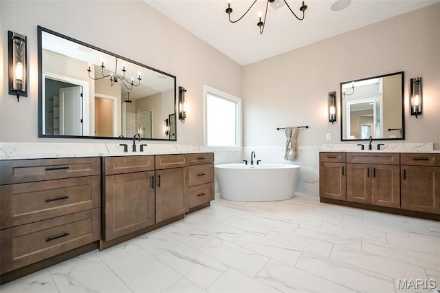 712 Silver Buck Ln, Chesterfield, MO 63005 - full bathroom featuring a chandelier, marble finish floors, a freestanding tub, two vanities, and tile walls