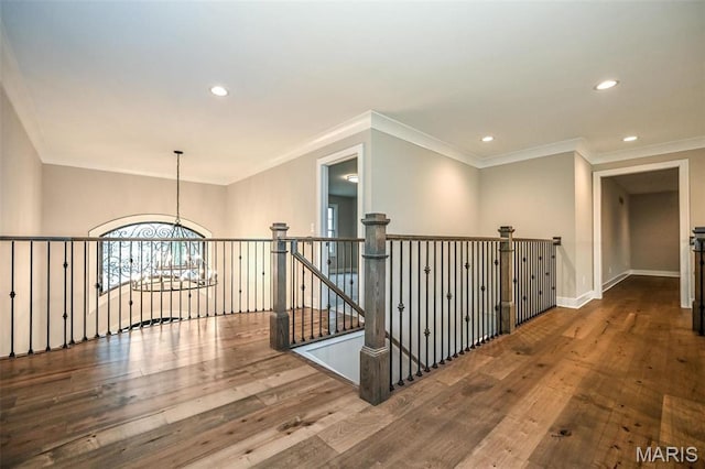 712 Silver Buck Ln, Chesterfield, MO 63005 - hall featuring wood-type flooring, recessed lighting, crown molding, a chandelier, and an upstairs landing