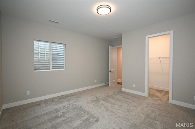 712 Silver Buck Ln, Chesterfield, MO 63005 - unfurnished bedroom featuring a walk in closet and carpet floors