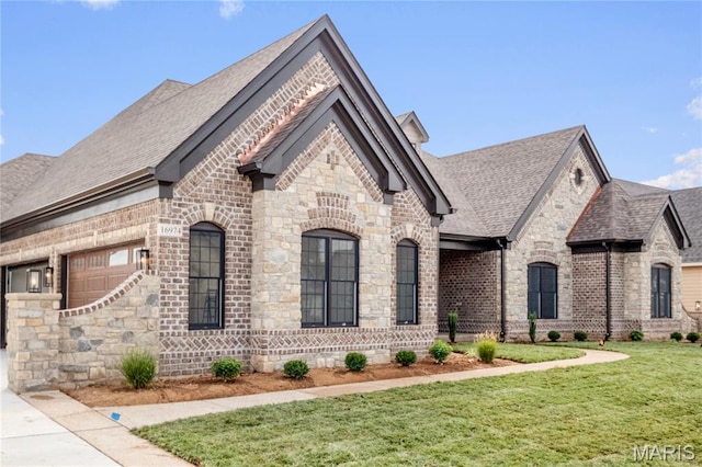 724 Silver Buck Ln, Chesterfield, MO 63005 - french country home with a front lawn, a shingled roof, brick siding, and stone siding