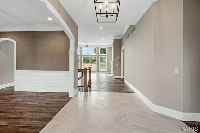 724 Silver Buck Ln, Chesterfield, MO 63005 - corridor featuring a chandelier, recessed lighting, crown molding, arched walkways, and an upstairs landing