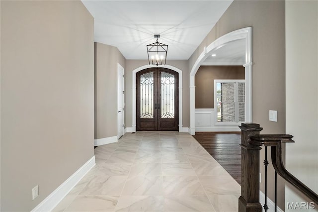 724 Silver Buck Ln, Chesterfield, MO 63005 - entrance foyer featuring arched walkways, french doors, and a chandelier