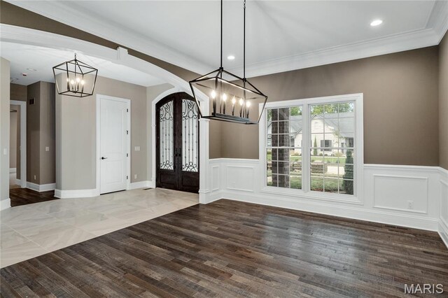 724 Silver Buck Ln, Chesterfield, MO 63005 - entryway featuring a chandelier, arched walkways, french doors, wainscoting, and wood finished floors