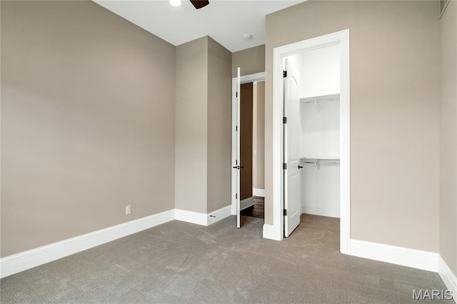 724 Silver Buck Ln, Chesterfield, MO 63005 - unfurnished bedroom with carpet floors, a walk in closet, a closet, and ceiling fan