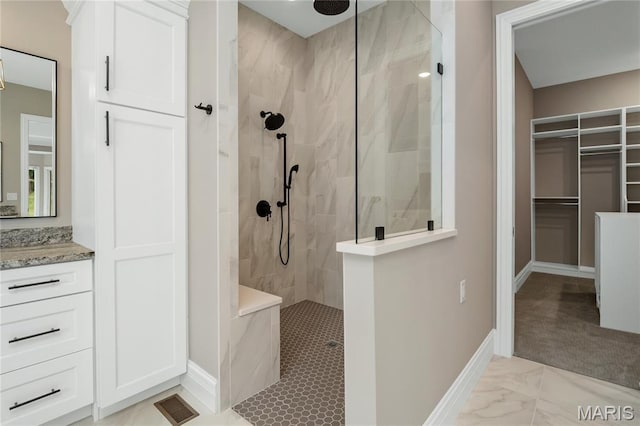 724 Silver Buck Ln, Chesterfield, MO 63005 - full bathroom featuring walk in shower, a spacious closet, vanity, and marble look tile flooring
