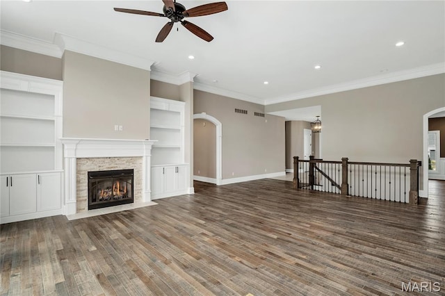 724 Silver Buck Ln, Chesterfield, MO 63005 - unfurnished living room featuring a ceiling fan, arched walkways, wood finished floors, crown molding, and recessed lighting