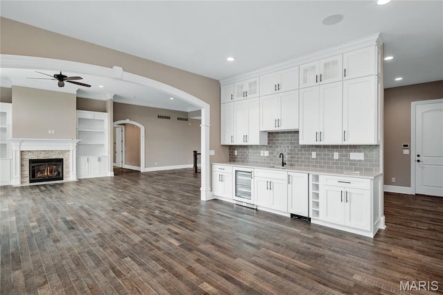 724 Silver Buck Ln, Chesterfield, MO 63005 - kitchen with ceiling fan, light countertops, white cabinets, arched walkways, and recessed lighting