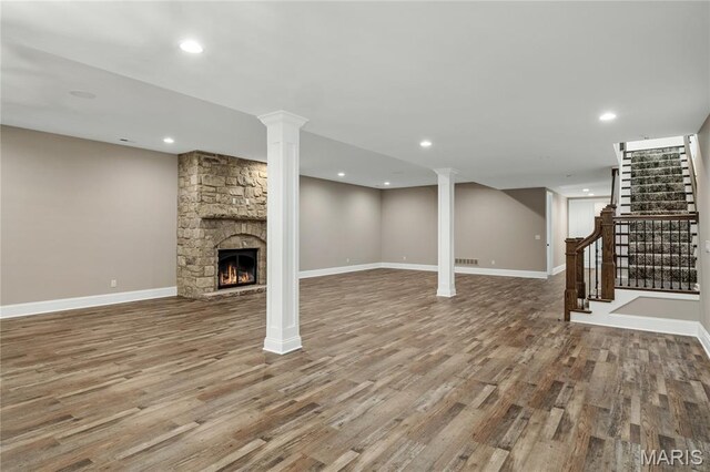 724 Silver Buck Ln, Chesterfield, MO 63005 - unfurnished living room with wood finished floors, a fireplace, stairs, and recessed lighting
