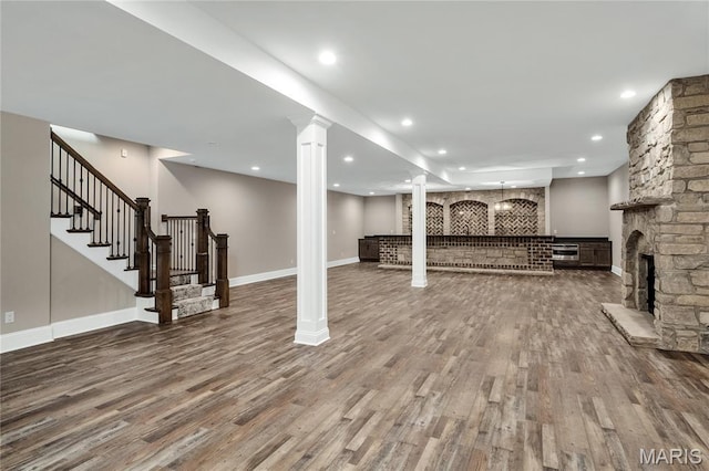 724 Silver Buck Ln, Chesterfield, MO 63005 - finished basement featuring wood finished floors, a fireplace, stairway, and recessed lighting