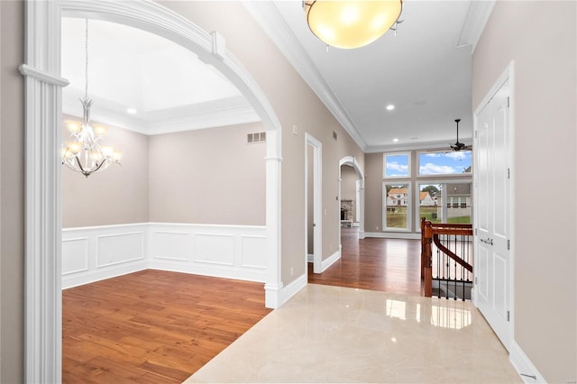 744 Silver Buck Ln, Chesterfield, MO 63005 - hall with arched walkways, wood finished floors, ornamental molding, a chandelier, and recessed lighting