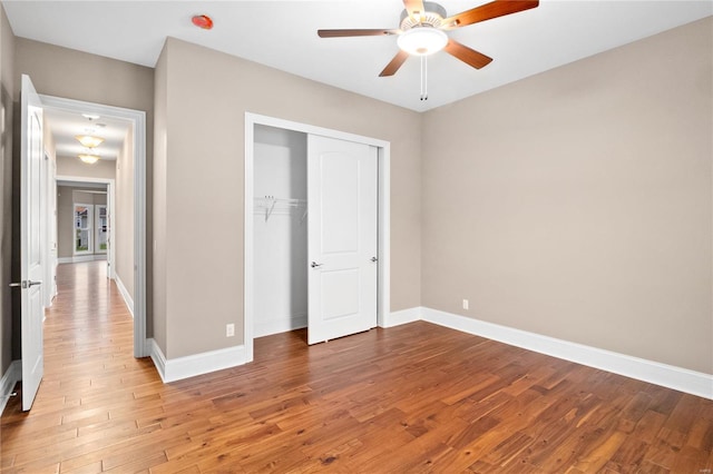 744 Silver Buck Ln, Chesterfield, MO 63005 - unfurnished bedroom with wood finished floors, a closet, baseboards, and a ceiling fan
