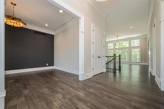 spare room with a chandelier, crown molding, baseboards, dark wood-style flooring, and recessed lighting
