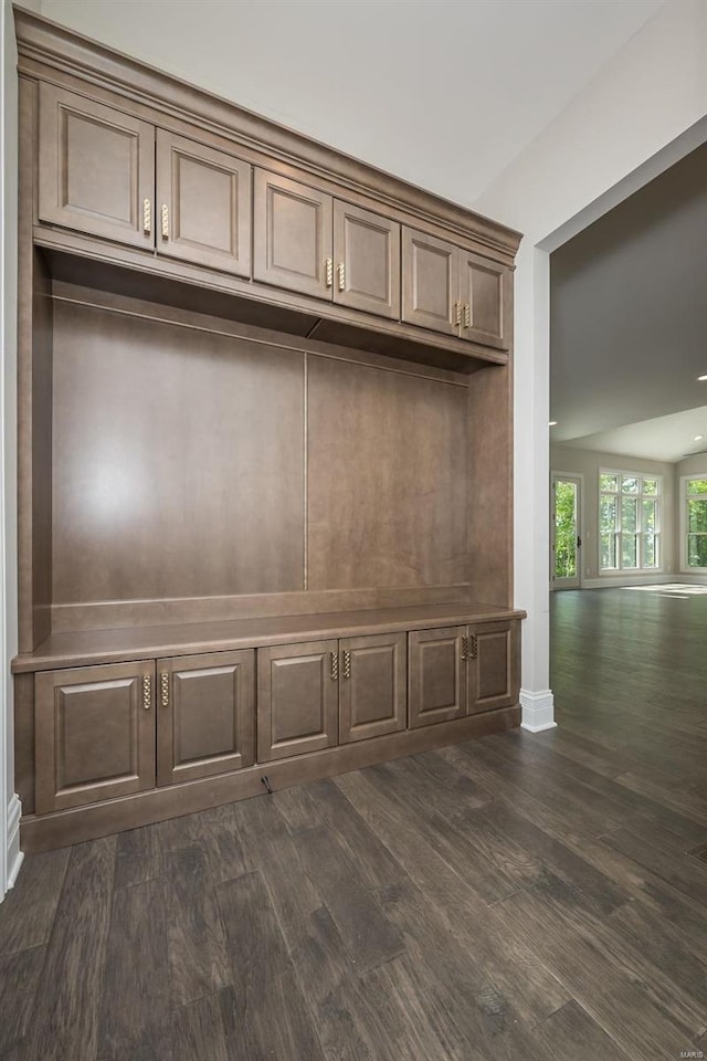 mudroom featuring dark wood-style flooring and baseboards