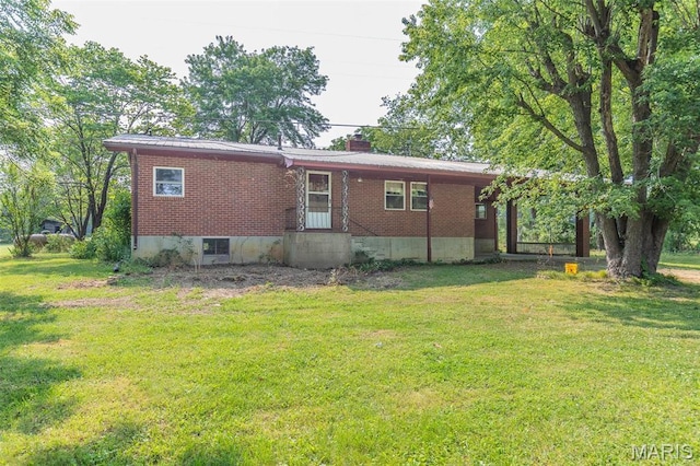 607 County Road 423, Poplar Bluff, MO 63901 - back of property featuring brick siding, a lawn, and a chimney