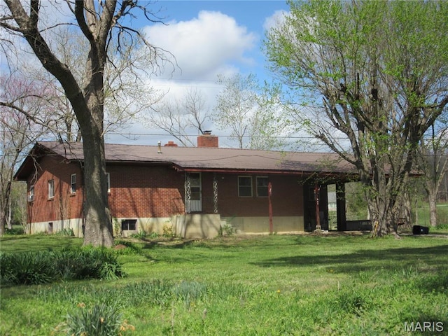 607 County Road 423, Poplar Bluff, MO 63901 - rear view of property with a yard and a chimney