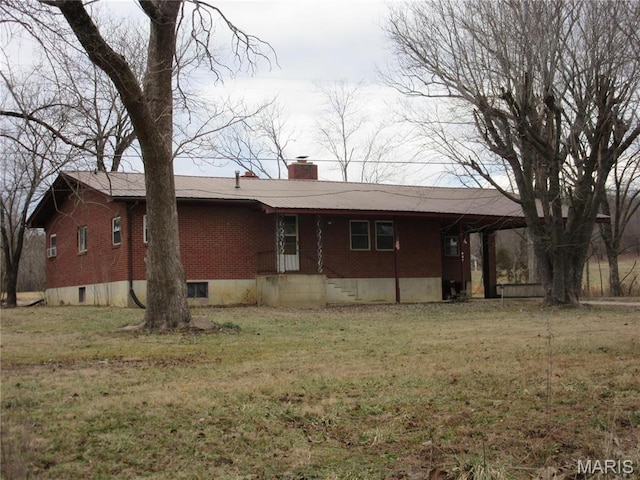 607 County Road 423, Poplar Bluff, MO 63901 - view of front facade featuring brick siding, a chimney, and a front lawn