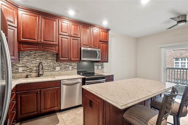 505 N And S Rd Unit 3C, University City, MO 63130 - kitchen with appliances with stainless steel finishes, a sink, decorative backsplash, a breakfast bar area, and recessed lighting
