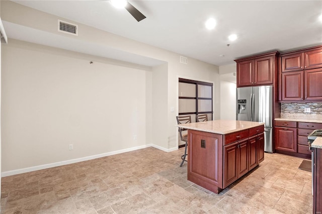 505 N And S Rd Unit 3C, University City, MO 63130 - kitchen featuring stainless steel refrigerator with ice dispenser, a center island, a breakfast bar, baseboards, and recessed lighting