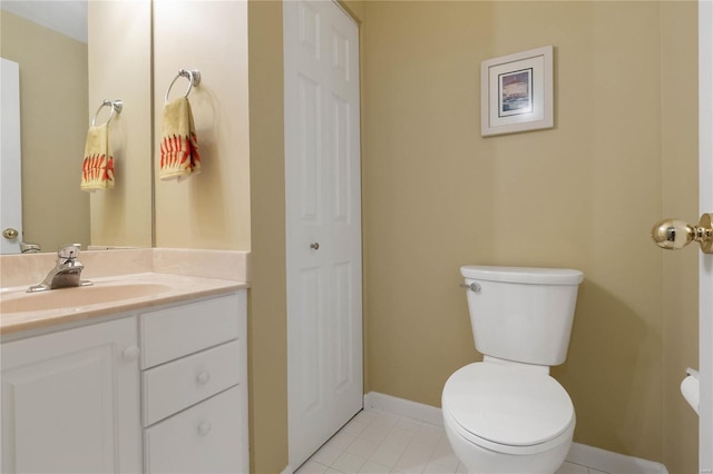 505 N And S Rd Unit 3C, University City, MO 63130 - bathroom featuring toilet, vanity, baseboards, and a closet