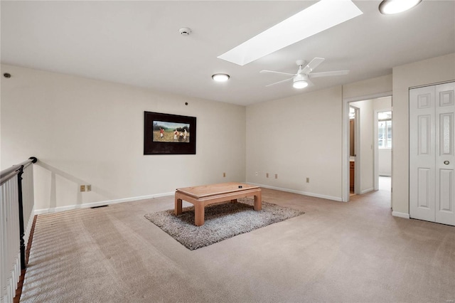 505 N And S Rd Unit 3C, University City, MO 63130 - unfurnished living room with a skylight, light colored carpet, baseboards, and ceiling fan