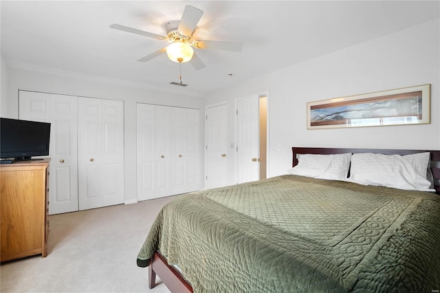 505 N And S Rd Unit 3C, University City, MO 63130 - bedroom featuring multiple closets, light carpet, and a ceiling fan